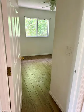 Empty room with wood finished floors and ceiling fan