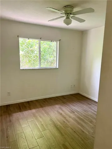Unfurnished room with light wood-style floors, a ceiling fan, and a textured ceiling