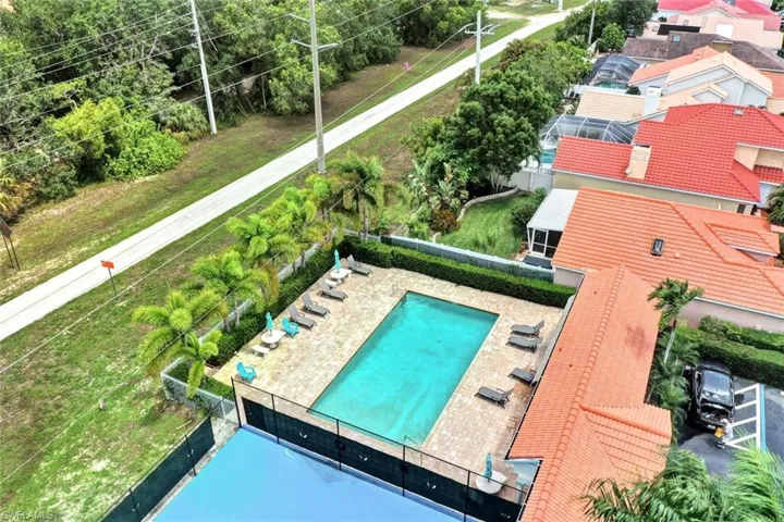 View of drone / aerial view of the community pool and amenities.