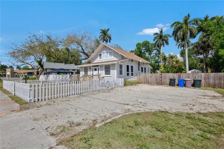 Bungalow with a fenced front yard and driveway
