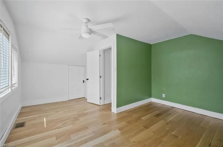 Bonus room featuring lofted ceiling, light wood-type flooring, and ceiling fan