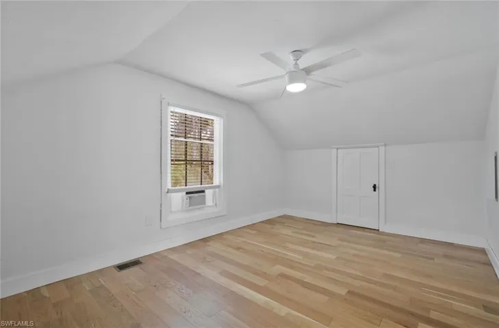 Additional living space featuring a ceiling fan and light wood-type flooring