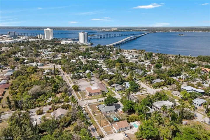 Aerial view of residential area with a notable bridge and a large body of water
