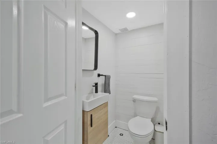 Bathroom featuring vanity, tile patterned floors, and recessed lighting