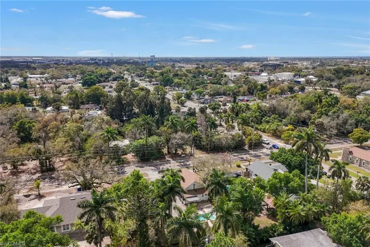 Aerial view of residential area featuring a tree filled landscape