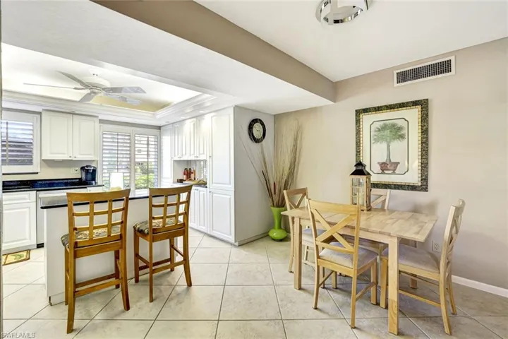 Dining area featuring ceiling fan and light tile patterned floors