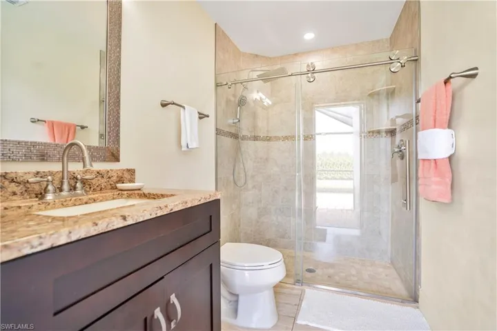 Bathroom with vanity and a shower stall