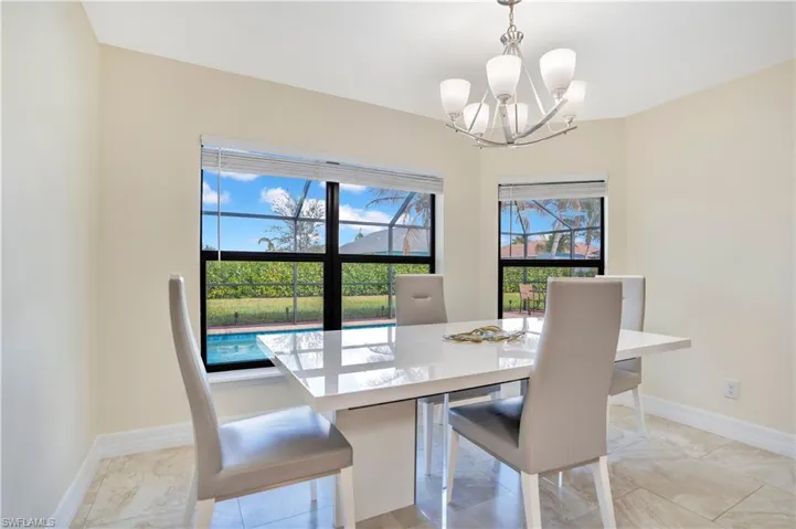 Dining area featuring baseboards and suspended lighting