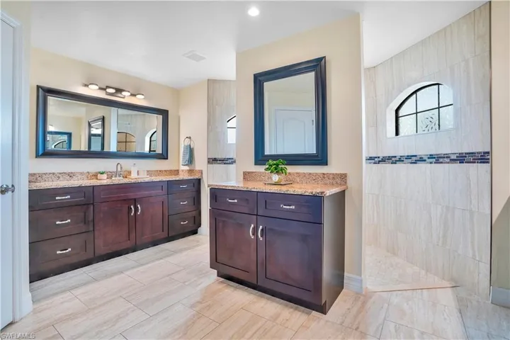 Bathroom featuring vanity and a walk in shower