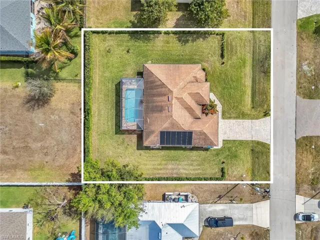 Aerial view of property and surrounding area with property parcel outlined