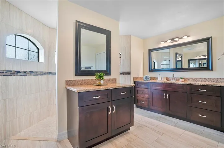 Bathroom featuring vanity and a walk in shower