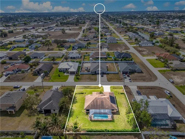 Aerial perspective of suburban area featuring property parcel outlined
