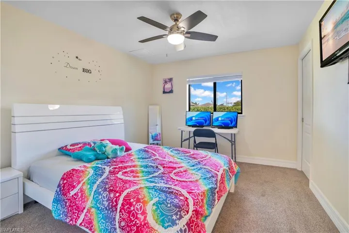 Bedroom featuring light carpet and ceiling fan