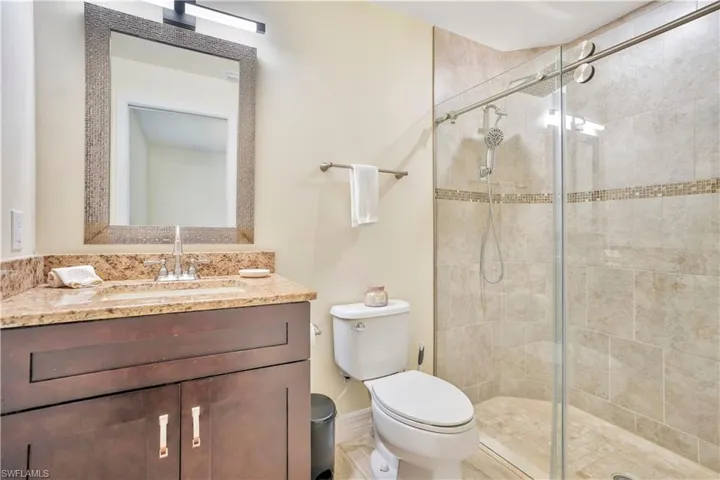 Full bathroom with vanity and a stall shower