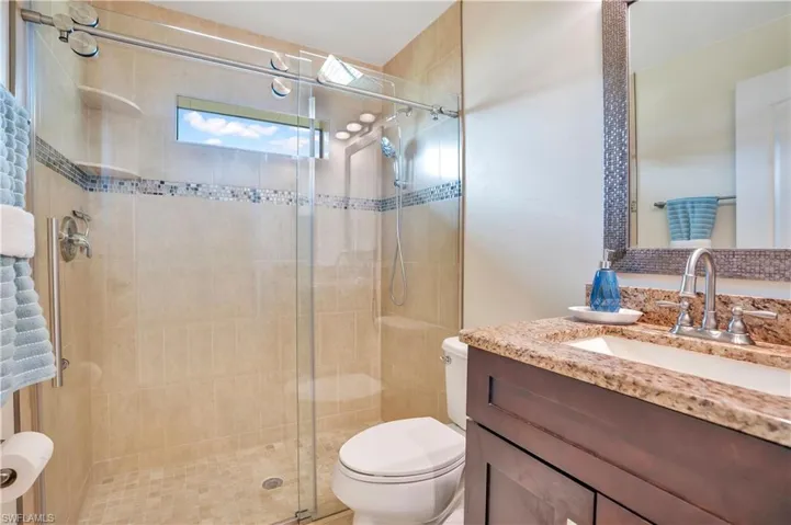 Bathroom featuring vanity and a stall shower