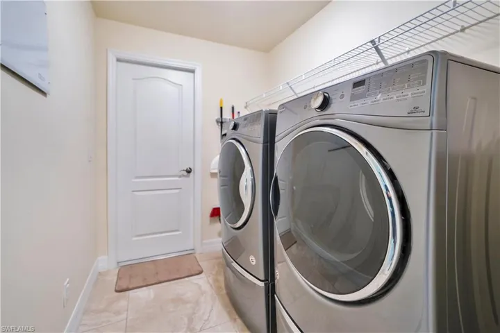 Laundry room with washer and dryer and baseboards