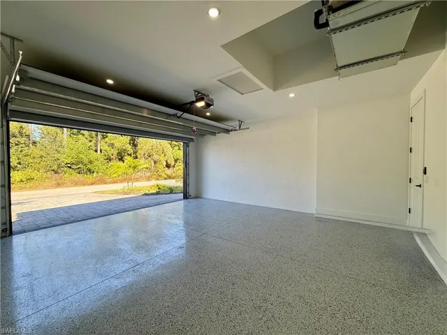 Garage featuring recessed lighting and a garage door opener