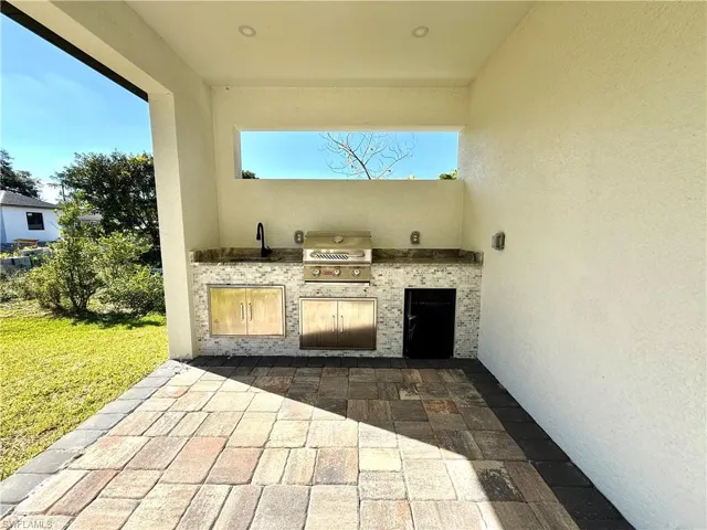 View of patio / terrace with area for grilling and a sink