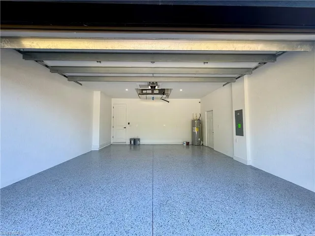 Garage with water heater and electric panel