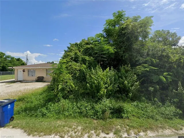 View of property hidden behind natural elements