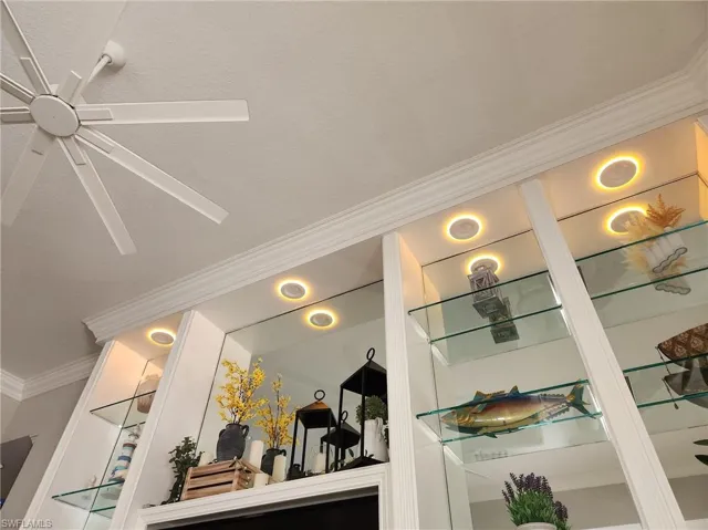 Details with a ceiling fan and ornamental molding