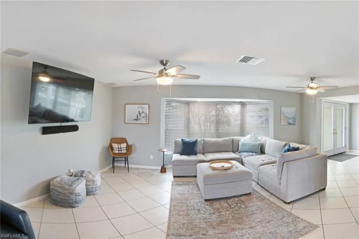 Tiled living room featuring ceiling fan