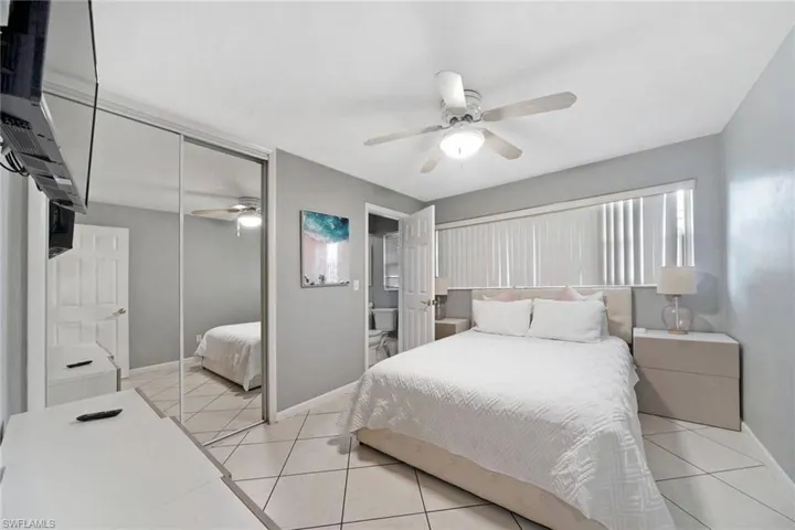 2nd Bedroom with ceiling fan, a closet, and light tile patterned floors and in suite bathroom.
