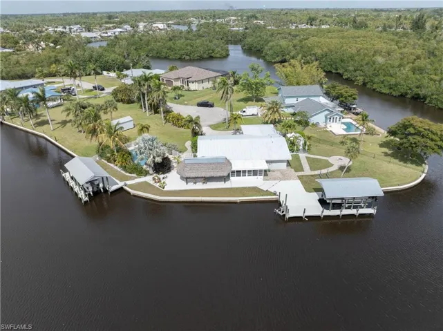 Property is Huge!  Both of the covered Boat lifts are included on the property.  Property line goes from the black fence on the Right side all the way to the shed to the left of the pool.