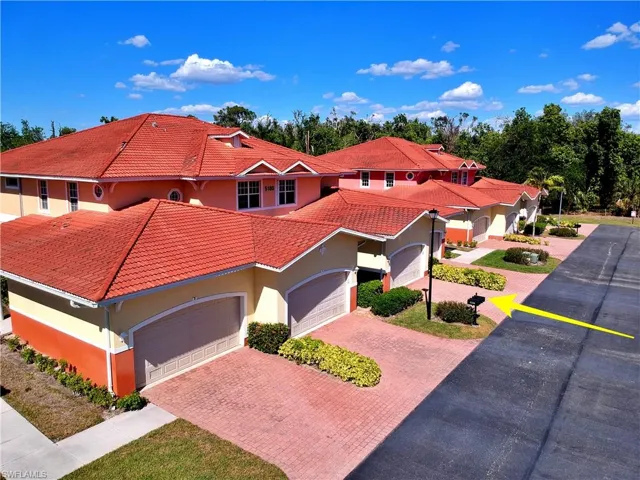 Mediterranean / spanish-style home featuring a tiled roof, stucco siding, an attached garage, and driveway