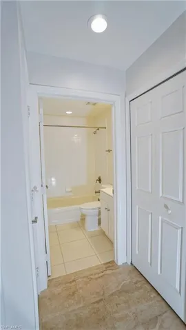 Bathroom featuring tile patterned floors, vanity, toilet, and bathing tub / shower combination