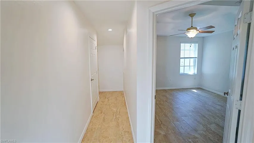 Hallway featuring baseboards and light wood finished floors