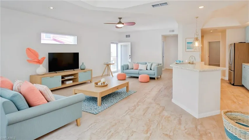 Living area featuring visible vents, recessed lighting, and a ceiling fan (virtual staged photos)