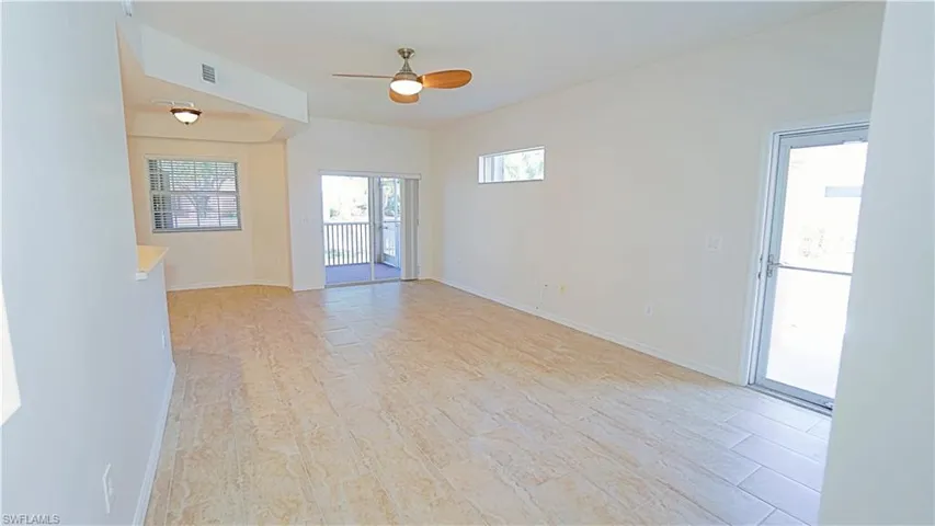 Unfurnished room featuring visible vents, baseboards, and ceiling fan