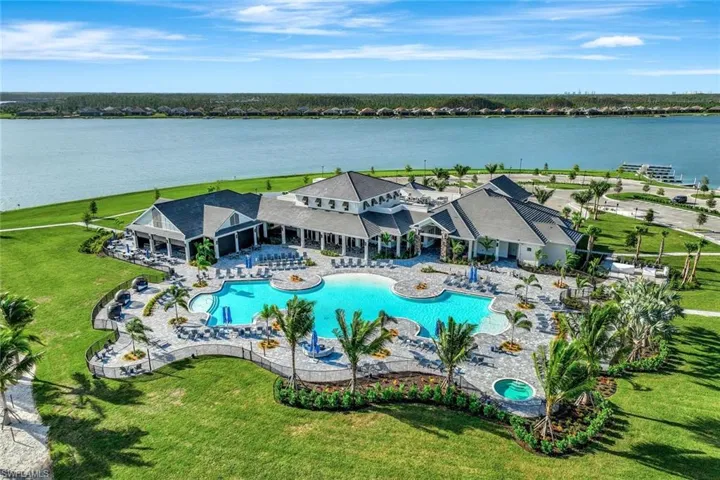 Birds eye view of property with a water view