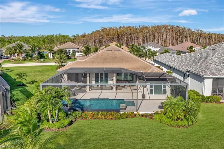 Back of house featuring a yard, a patio, and a lanai