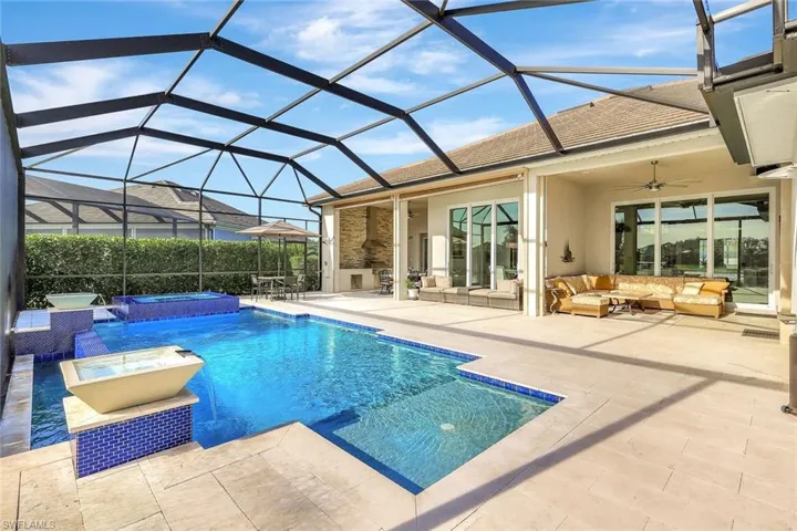 View of pool with an in ground hot tub, an outdoor living space, ceiling fan, glass enclosure, and a patio