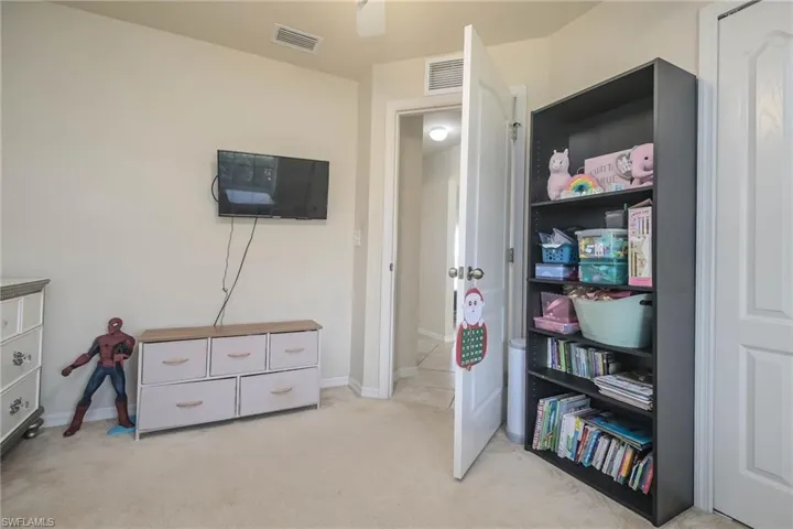 Game room with light colored carpet