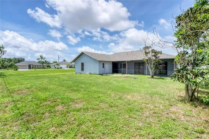 Back of house featuring a lawn