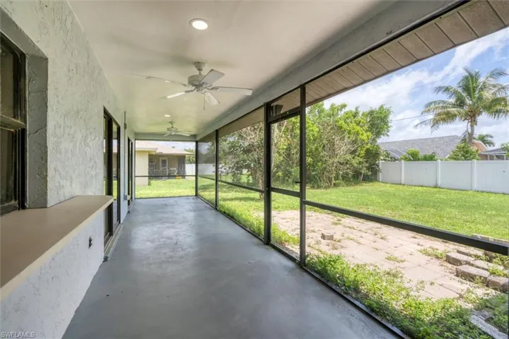 Unfurnished sunroom featuring ceiling fan