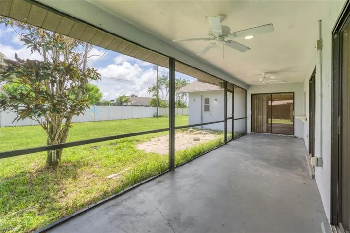 Unfurnished sunroom featuring ceiling fan