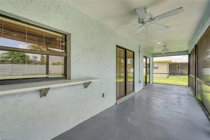 Unfurnished sunroom with ceiling fan