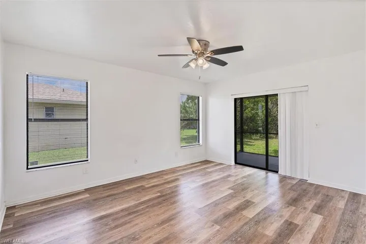 Unfurnished room with hardwood / wood-style floors and ceiling fan