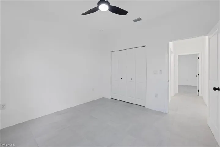 Unfurnished bedroom featuring a closet and a ceiling fan