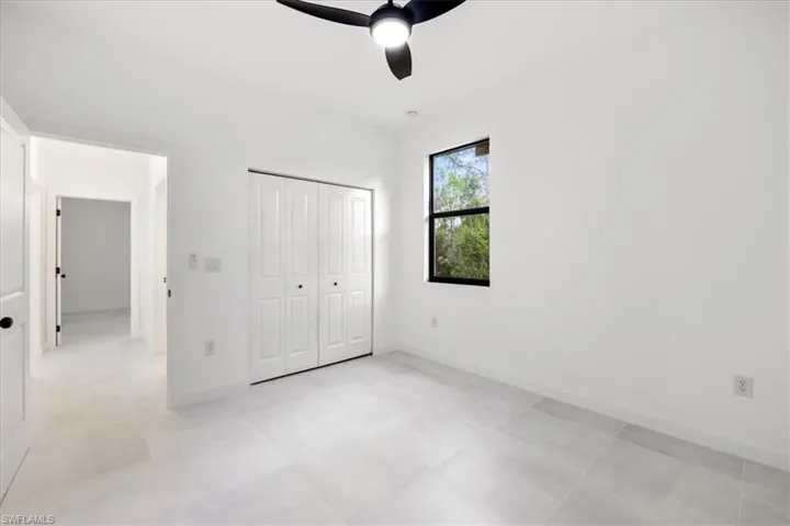Unfurnished bedroom featuring a closet and a ceiling fan