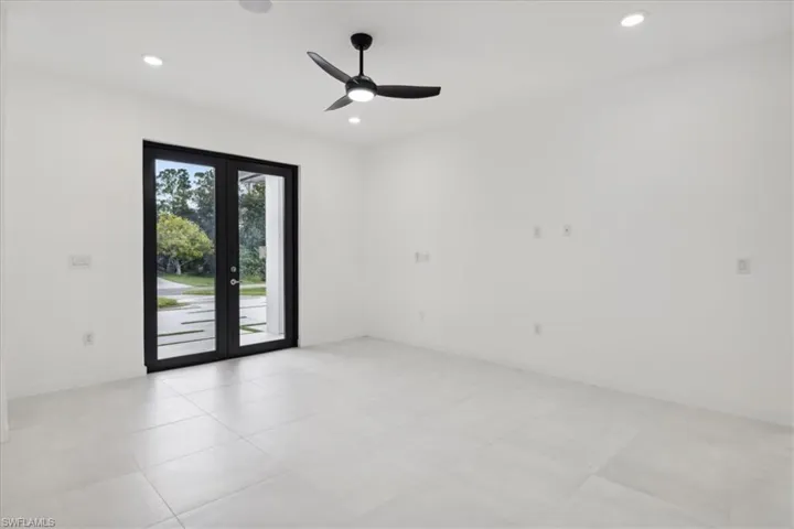 Empty room with a ceiling fan and recessed lighting