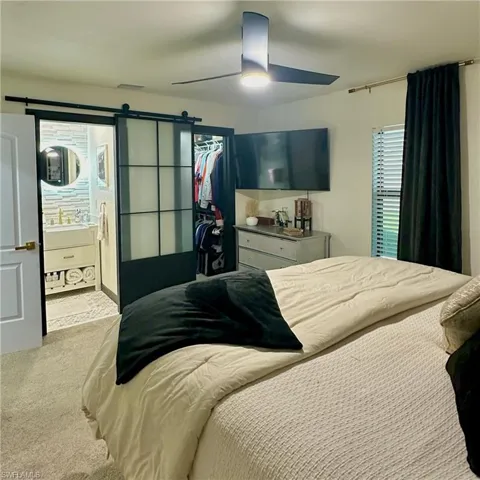 Primary Bedroom, Frosted Glass Barn Door Leading into the Primary Bathroom, Walk-in Closet.