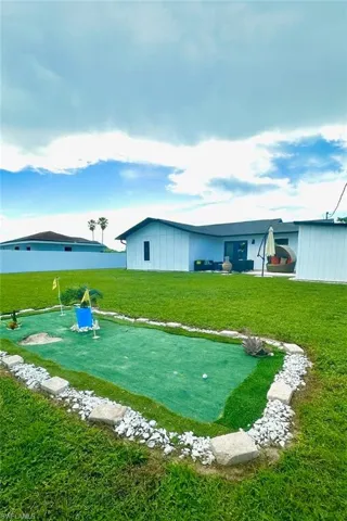Fully fenced backyard with patio and putting green.
