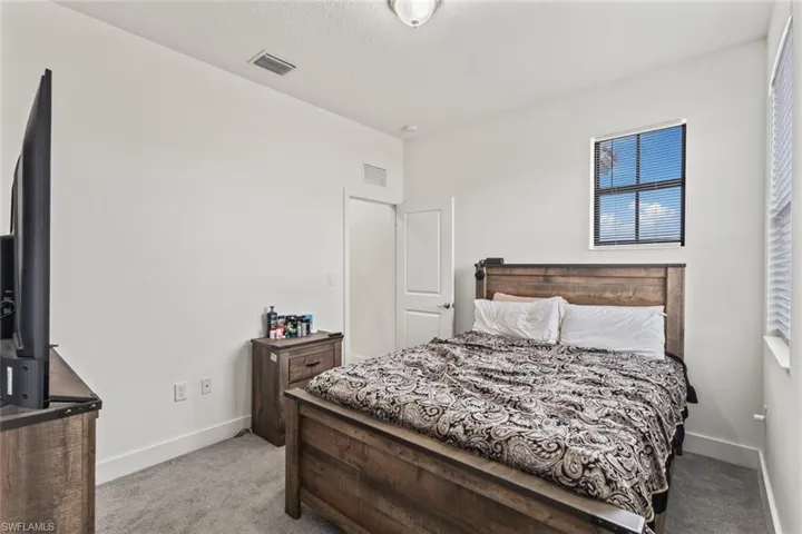 Bedroom with light carpet