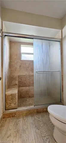 Bathroom with a shjavascript:ManageMediaJS.clickPermanent(22);ower with door and toilet