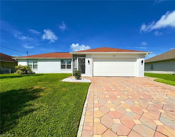 Single family home featuring a 2-car garage and a front lawn